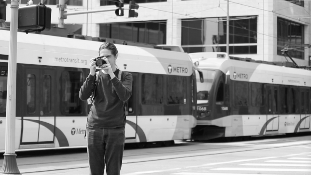 Image of subject taking a picture near a train stop